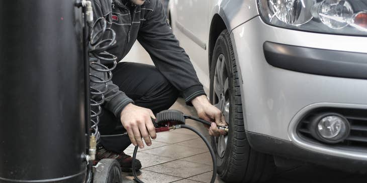 A mechanic performing automotive duties.