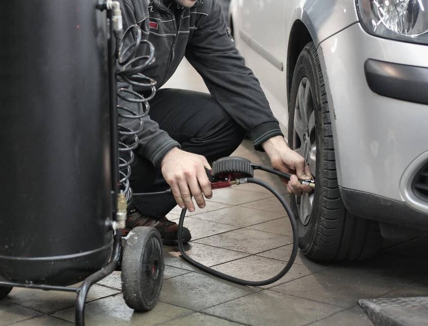 A mechanic performing automotive duties.