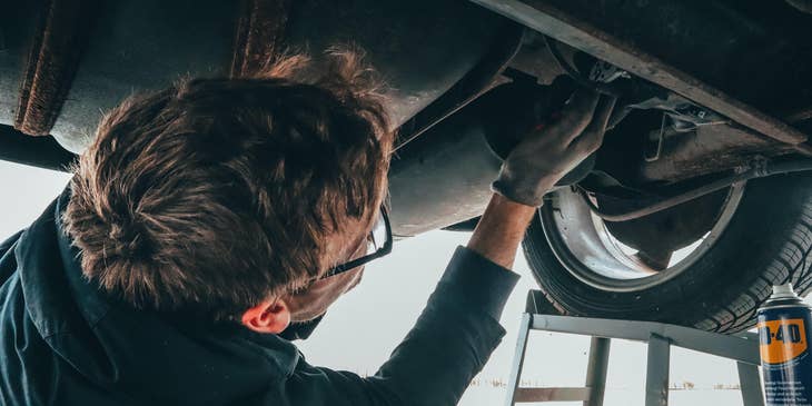 Automotive Technician checking under a vehicle