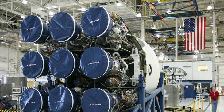 Avionics Technician looking at the new rocket construction to be installed in the new spacecraft