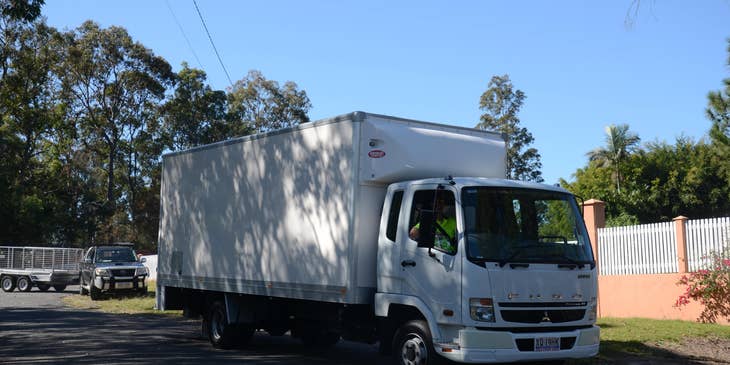 An AZ DZ Driver driving a delivery truck on his way to transport products across the border on a sunny day.