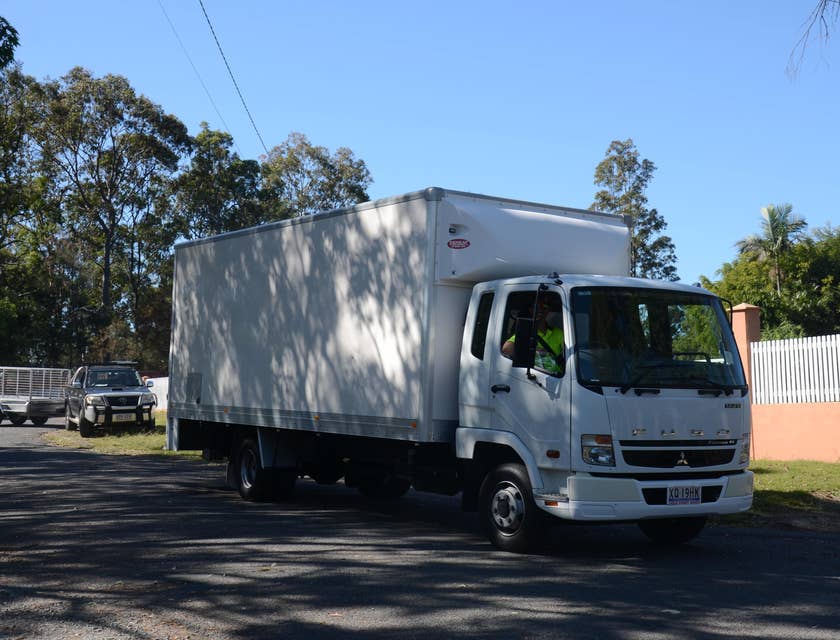 An AZ DZ Driver driving a delivery truck on his way to transport products across the border on a sunny day.