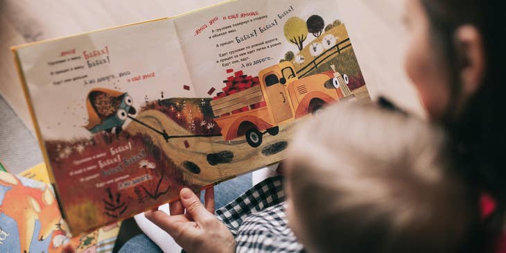 Babysitter reading a storybook to a baby