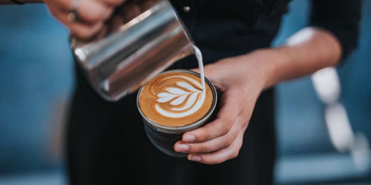 Barista showing exceptional latte art skill.
