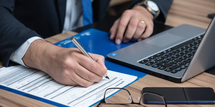 A Barrister writing on a legal document in preparation for a case.