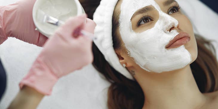 Beauty Therapist doing a skin treatment on a client's face