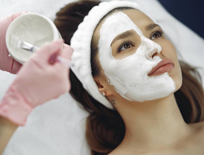 Beauty Therapist doing a skin treatment on a client's face