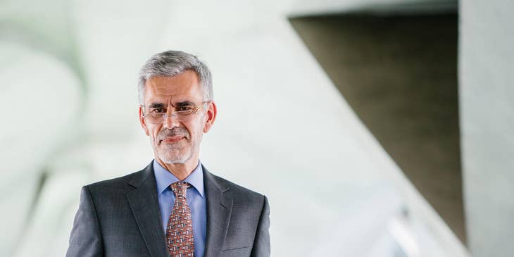 A professional wearing a grey suit.