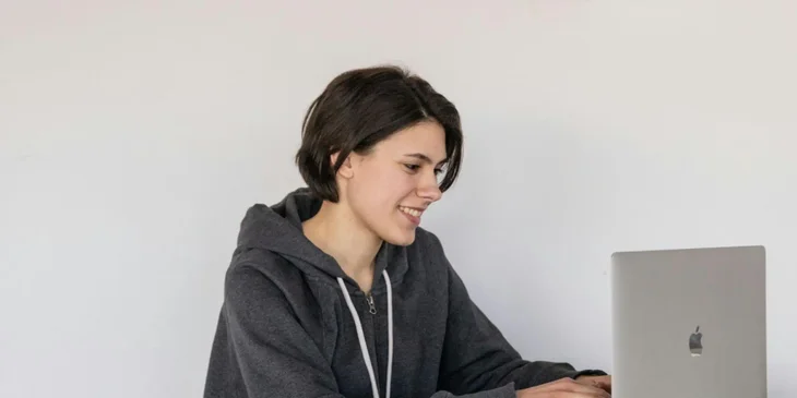 A woman working on a laptop at home.