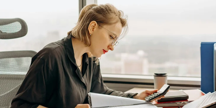 An accountant engaged in tasks at her desk.
