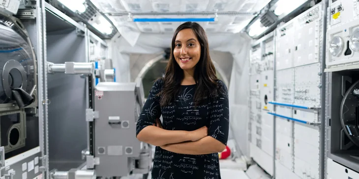 A female engineer standing in a space station.