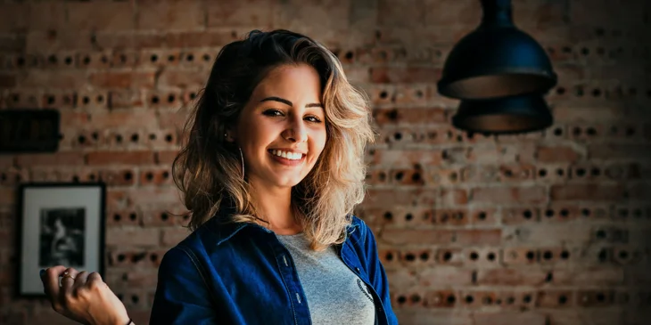 A woman posing with a smile for the camera.