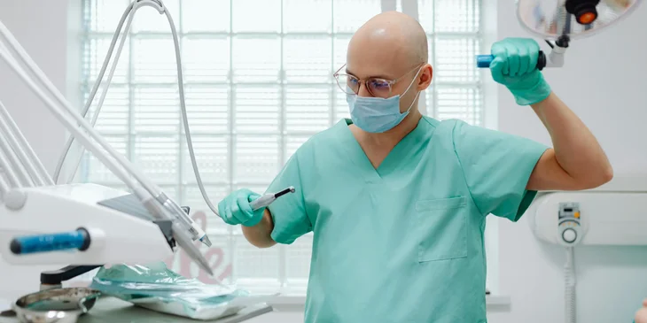 An anesthetist inspecting the surgical tools for an upcoming procedure.