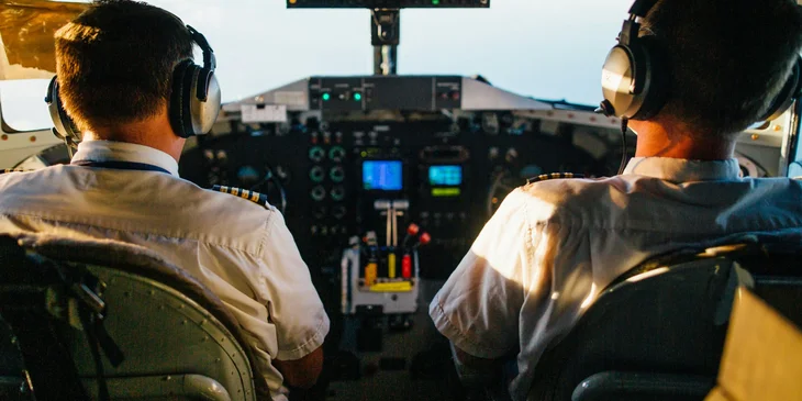 Two pilots flying an airplane.
