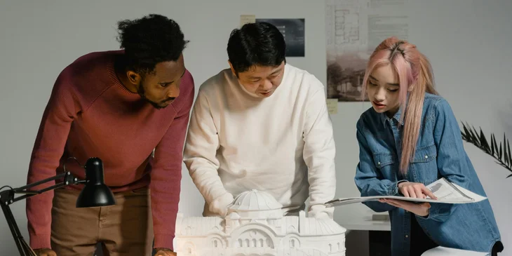 Three people collaborating on a project.