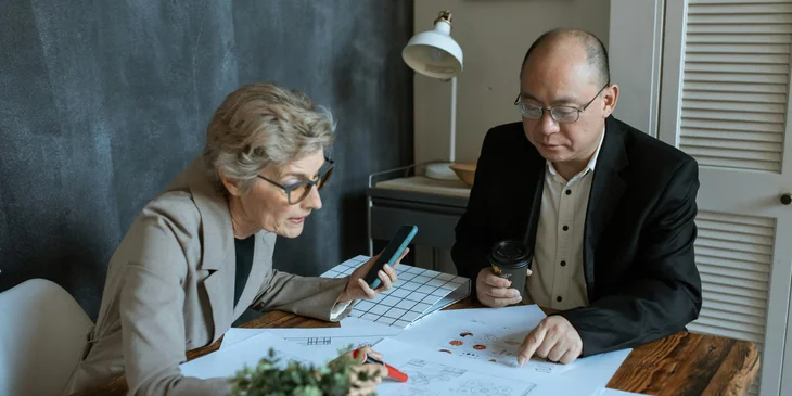An architectural drafter checks the drawing done for a client presentation.