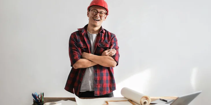 An architect posing for a photo with a smile.