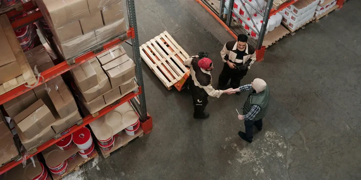 An assistant buyer shakes the hand of a client.