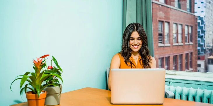 A woman using a laptop.