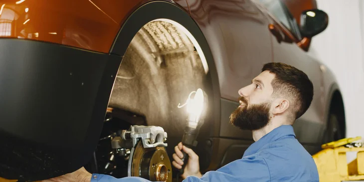 A mechanic checking the car.