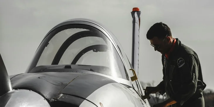 A pilot opening the airplane door.