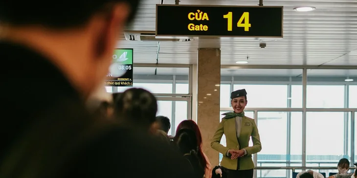 A flight attendant waiting at the boarding gate.