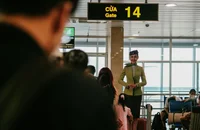 A flight attendant waiting at the boarding gate.