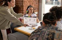 Degli attori che registrano una scena aiutati da vari operatori.