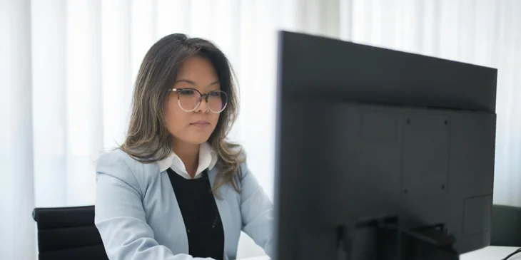 A back office executive working on her computer.