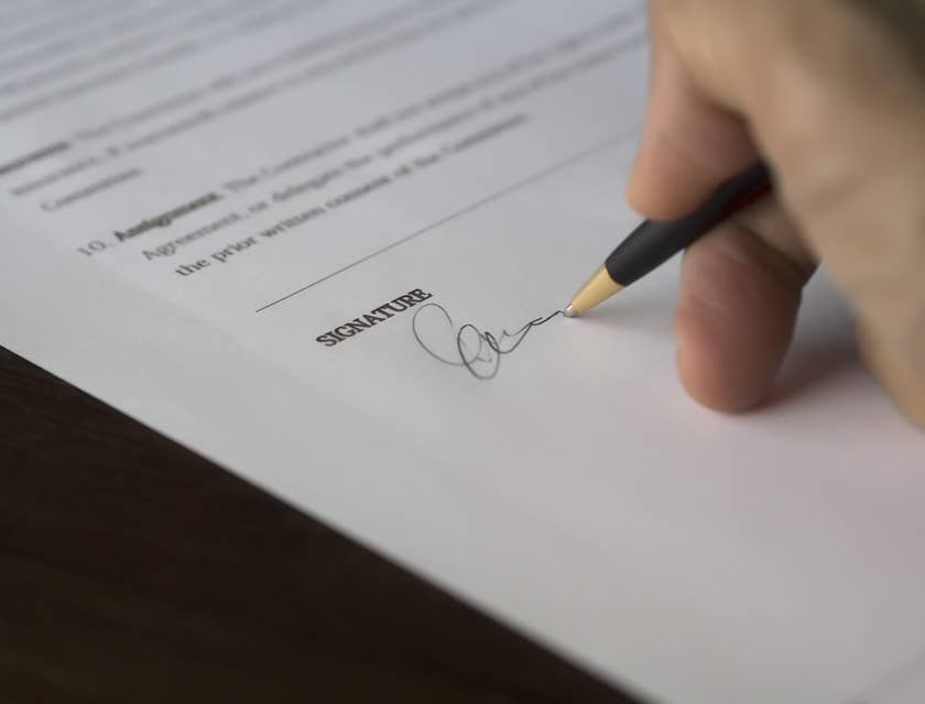 A person signing a background check authorization form.