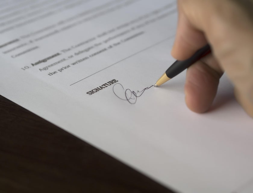 A person signing a background check authorization form.