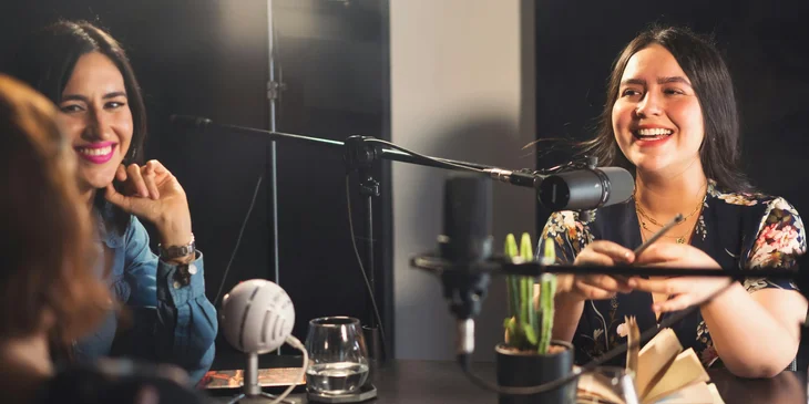 Women having a conversation in a studio.