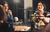 Women having a conversation in a studio.