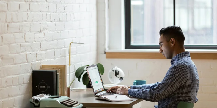 A man busy working on his laptop.