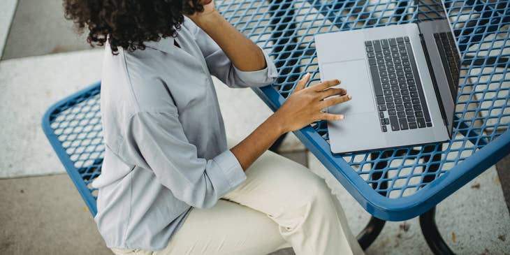 Freelance writer working on a gray laptop.