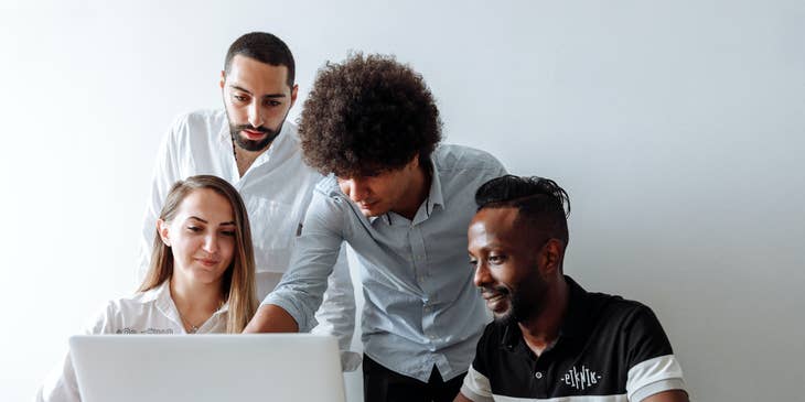 A group of people reviewing the best job boards for 2024 on a laptop.