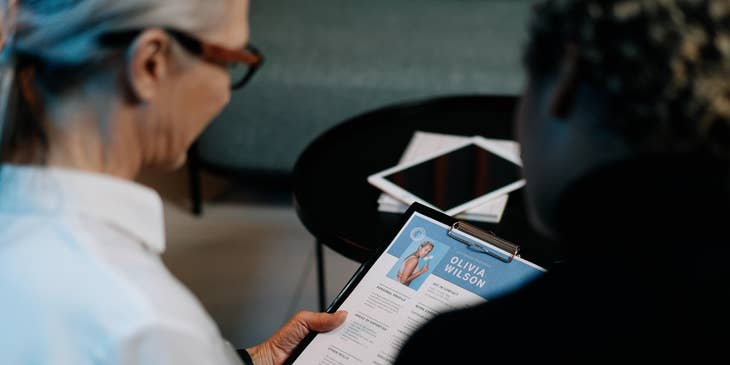 Two women reading a resume