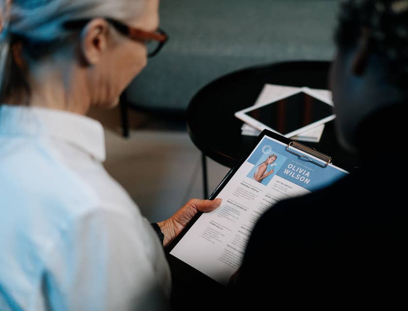 Two women reading a resume