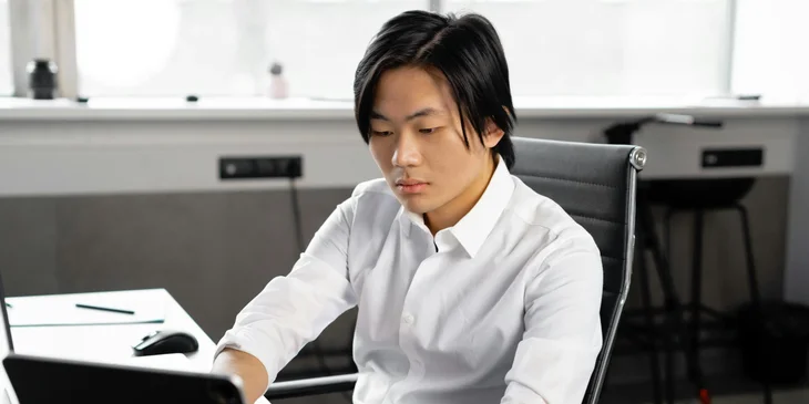 A man working on his laptop.
