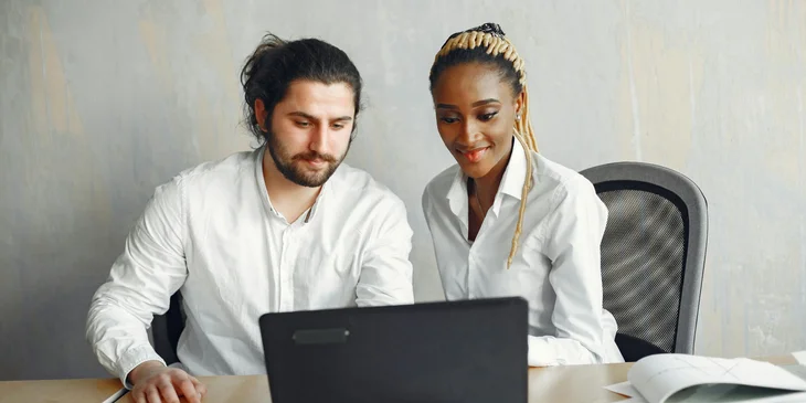 Colleagues working on a laptop.