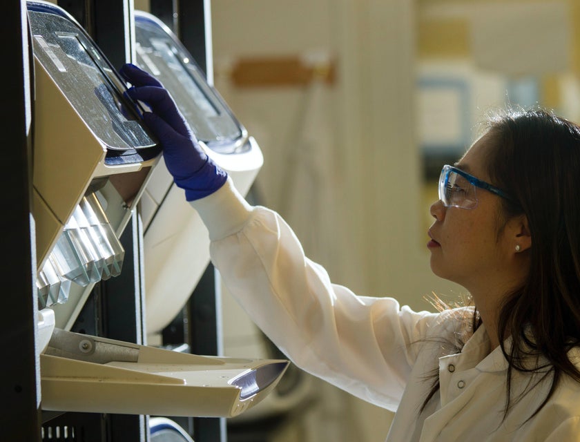 A biomedical technician preparing an experiment in a laboratory.