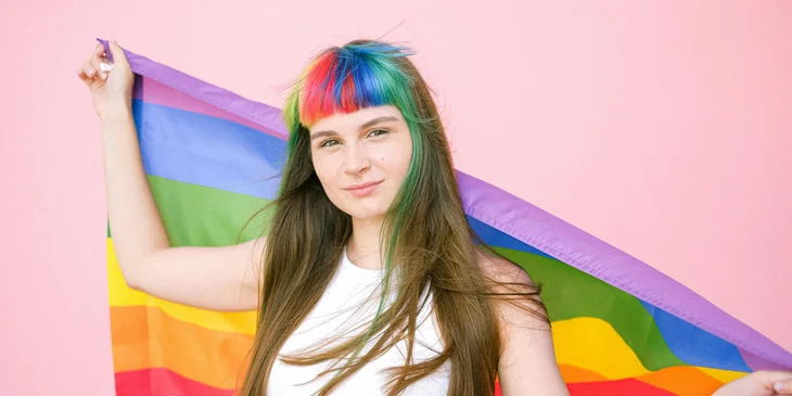 A woman holding the pride flag.