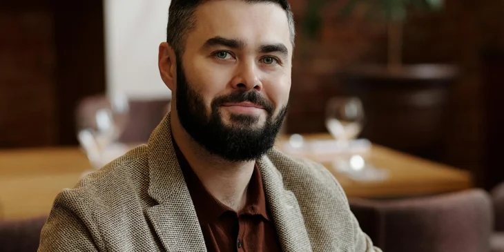 A man sitting and looking at the camera.