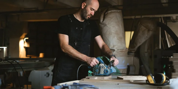 A craftsman polishing wood.