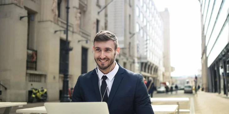 A man in suit working outdoors.