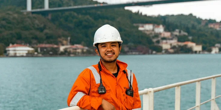 A worker standing on a bridge.