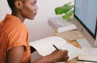 Una mujer escribiendo una carta de presentación para un empleo.
