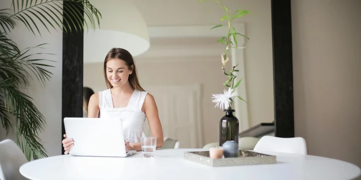 A woman working on her laptop.