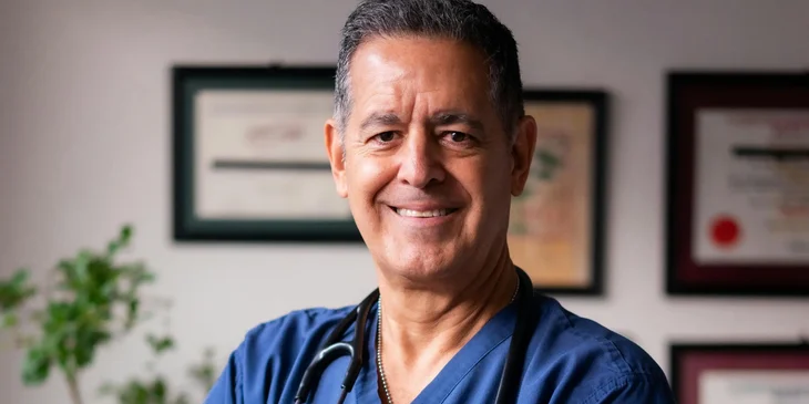 A doctor wearing scrubs.