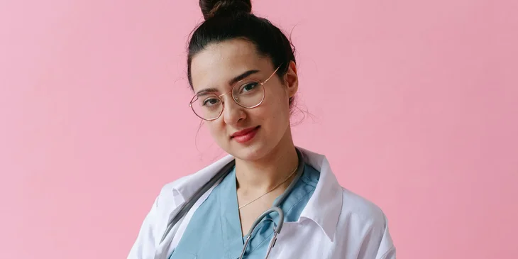 A woman in a white button up shirt.